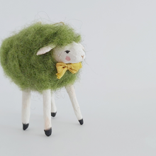 Load image into Gallery viewer, A closer view of the green needle felted sheep's face, against a white background. Pic 4 of 7.