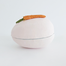 Load image into Gallery viewer, A side view of a vintage style, light pink paper mache egg box. A spun cotton carrot adorns the top. Pic 10 of 12.
