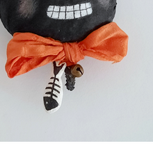 Load image into Gallery viewer, A close-up of a spun cotton fish and jingle bell hanging from a silk sari bow tie. Pic 3 of 6.
