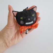 Load image into Gallery viewer, A vintage style, spun cotton black cat ornament held in a hand against a white background. Pic 2 of 6.