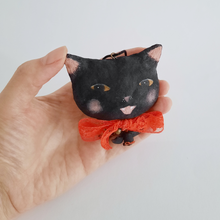 Load image into Gallery viewer, A vintage style, spun cotton black cat ornament held in a hand against a white background. Pic 2 of 7.