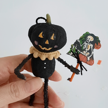 Load image into Gallery viewer, A close up view of a vintage style, spun cotton black pumpkin man ornament and the skeleton sign he's holding. Pic 3 of 7.