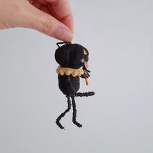 Load image into Gallery viewer, A side view of a vintage style, spun cotton black pumpkin man ornament. Pic 4 of 7.