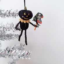 Load image into Gallery viewer, A vintage style, spun cotton black pumpkin man ornament hanging on a silver tree. Pic 1 of 7.