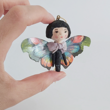 Load image into Gallery viewer, Close up of a vintage style spun cotton butterfly girl, held in hand. Pic 3 of 7.