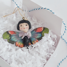 Load image into Gallery viewer, A vintage style spun cotton butterfly girl laying in a white gift box, on white tissue shredding. Pic 4 of 7.