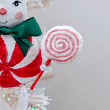 Load image into Gallery viewer, A close-up of a spun cotton pink swirl lollipop, held by a vintage style spun cotton candy man. Pic 5 of 8.
