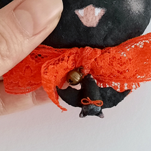 Load image into Gallery viewer, Another close-up of a spun cotton bat hanging on a vintage orange lace bow. Pic 4 of 7.