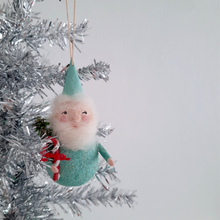 Load image into Gallery viewer, A spun cotton, mint green gnome hanging on a silver tinsel tree.
