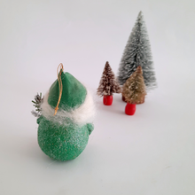 Load image into Gallery viewer, The back view of a spun cotton gnome ornament on a white background with miniature Christmas trees.