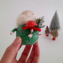 Load image into Gallery viewer, A close-up of a hand holding a spun cotton gnome with a red mushroom, with miniature bottle brush trees in the background.
