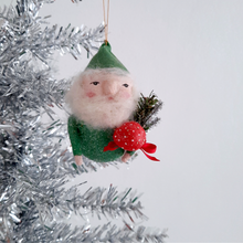 Load image into Gallery viewer, A spun cotton gnome with a green hat and holding a red mushroom, on a silver tinsel tree.