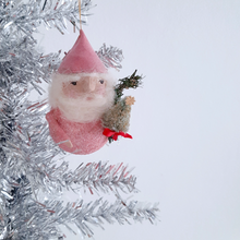 Load image into Gallery viewer, A spun cotton gnome ornament with pink hat, holding a bottle brush tree, hanging on a silver tinsel tree.