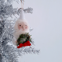 Load image into Gallery viewer, A spun cotton gnome, holding a wreath and hanging on a silver tinsel tree.