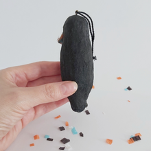 Load image into Gallery viewer, The back view of a vintage style spun cotton crow ornament against a white background, over Halloween confetti. Pic 6 of 8.