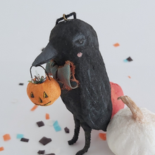 Load image into Gallery viewer, A close up view of the face of a vintage style spun cotton crow ornament, against a white background. Spun cotton white and orange pumpkins sit behind him on Halloween confetti. Pic 2 of 8.