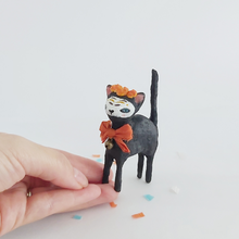 Load image into Gallery viewer, A vintage style spun cotton Day of the Dead black cat, standing on a hand against a white background. Pic 1 of 9.
