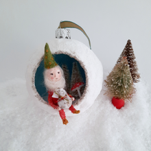 Load image into Gallery viewer, A vintage style, spun cotton gnome diorama ornament sitting on fake snow next to two vintage bottlebrush trees. Pic 1 of 5