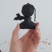 Load image into Gallery viewer, A back view of a vintage style spun cotton dracula ornament, held in hand against a white background. Pic 7 of 8.