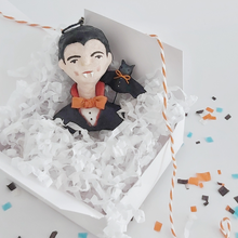 Load image into Gallery viewer, A vintage style spun cotton dracula ornament laying in a white gift box on white tissue shredding. Pic 5 of 8.