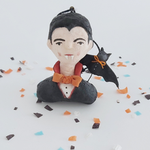 Load image into Gallery viewer, Vintage style spun cotton dracula ornament sitting on Halloween confetti against a white background. Pic 1 of 8.