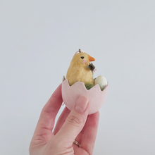 Load image into Gallery viewer, A side view of a vintage style, spun cotton Easter chick egg ornament held in a hand against a white background. Pic 5 of 7.
