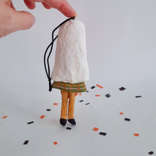 Load image into Gallery viewer, Back view of a vintage style, spun cotton ghost girl ornament against a white background on Halloween confetti. Pic 6 of 7.