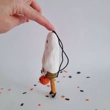 Load image into Gallery viewer, A side view of a vintage style, spun cotton ghost girl ornament against a white background on Halloween confetti. Pic 5 of 7.