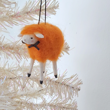 Load image into Gallery viewer, An orange, vintage style spun cotton needle felted sheep ornament hanging on a white tree. Pic 3 of 5.
