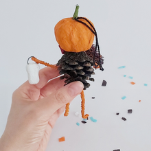 Load image into Gallery viewer, The back view of a vintage style spun cotton pinecone pumpkin man, held by hand against a white background. Pic 8 of 8.
