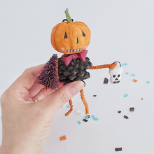 Load image into Gallery viewer, A vintage style spun cotton pinecone pumpkin man, held in hand on Halloween confetti against a white background. Pic 2 of 8.