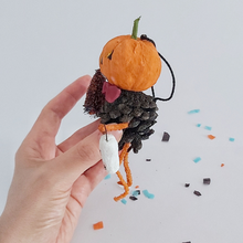 Load image into Gallery viewer, A side view of a vintage style spun cotton pinecone pumpkin man, held in hand against a white background. Pic 7 of 8.
