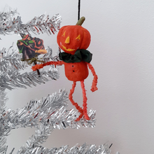 Load image into Gallery viewer, A vintage style, spun cotton pumpkin man ornament hanging on a silver tree. Pic 3 of 8.