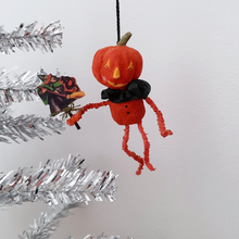 Load image into Gallery viewer, Another photo of a vintage style, spun cotton pumpkin man ornament hanging from a silver tree. Pic 7 of 8.