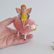 Load image into Gallery viewer, A hand holding a vintage style, spun cotton fairy on sheep ornament against a white background. Pic 1 of 7.
