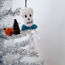Load image into Gallery viewer, A vintage style, spun cotton pipe cleaner skeleton hanging on a silver tree. Pic 5 of 5.