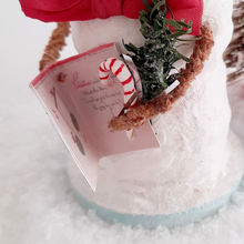 Load image into Gallery viewer, A close-up of a card, greenery, and spun cotton candy cane held by a vintage style snowman. Pic 1 of 6.