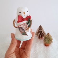Load image into Gallery viewer, A hand holding a vintage style, spun cotton snowman against a white background, next to two vintage bottlebrush trees. Pic 1 of 6.