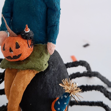 Load image into Gallery viewer, A close-up of the vintage style, spun cotton jack-o-lantern and spider sitting on a spun cotton girl's lap. Pic 6 of 10.