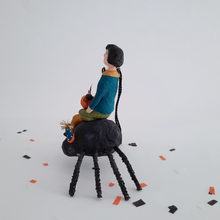 Load image into Gallery viewer, Another side view of a vintage style, spun cotton girl sitting on a spider. Pic 10 of 10.