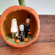 Load image into Gallery viewer, A close view of a vintage style, spun cotton trick-or-treaters ornament on a wood background. Pic 2 of 7.