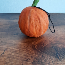 Load image into Gallery viewer, The back view of a spun cotton trick-or-treaters ornament on a dark wood background. Pic 7 of 7.