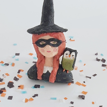 Cargar imagen en el visor de la galería, A closer view of a vintage style spun cotton witch girl ornament, sitting on Halloween confetti on a white background. Pic 3 of 9.