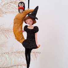 Load image into Gallery viewer, A vintage style, spun cotton witch on a moon ornament hanging on a tree.Pic 1 of 8.