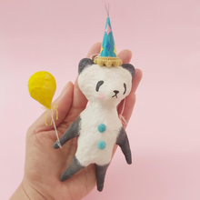Load image into Gallery viewer, Spun Cotton Panda ornament, holding yellow balloon and wearing a colourful party hat. Held in a hand. Picture 1