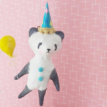 Load image into Gallery viewer, Spun cotton panda hanging from thread, in front of pink and white mid century wallpaper. Picture 6