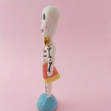 Load image into Gallery viewer, Side view of spun cotton skeleton sculpture, standing on turquoise base. Photo 6