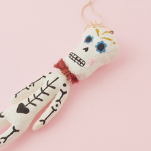 Load image into Gallery viewer, A side view of spun cotton skeleton ornament. Photo 5