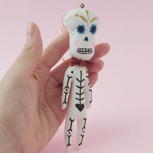 Load image into Gallery viewer, Spun cotton skeleton, held in hand. Photo 3