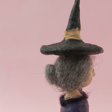 Load image into Gallery viewer, Side view of witch's grey needle felted hair bun and witch hat. Photo 10 of 11.